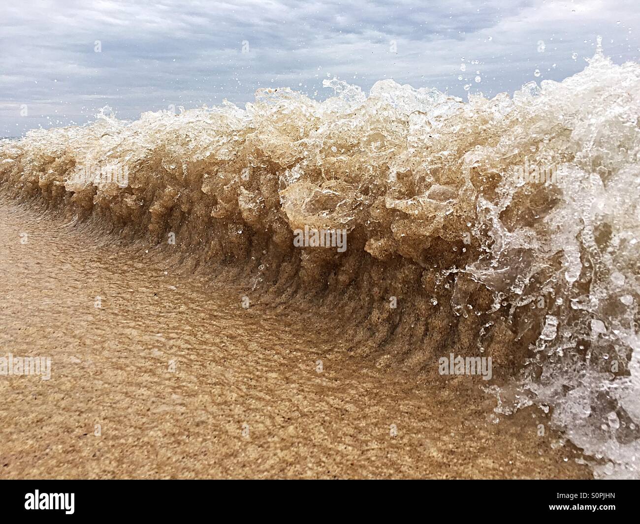 Change in wave shape as water comes in against the water that flows out tidal - Smartphone Captured Stock Image