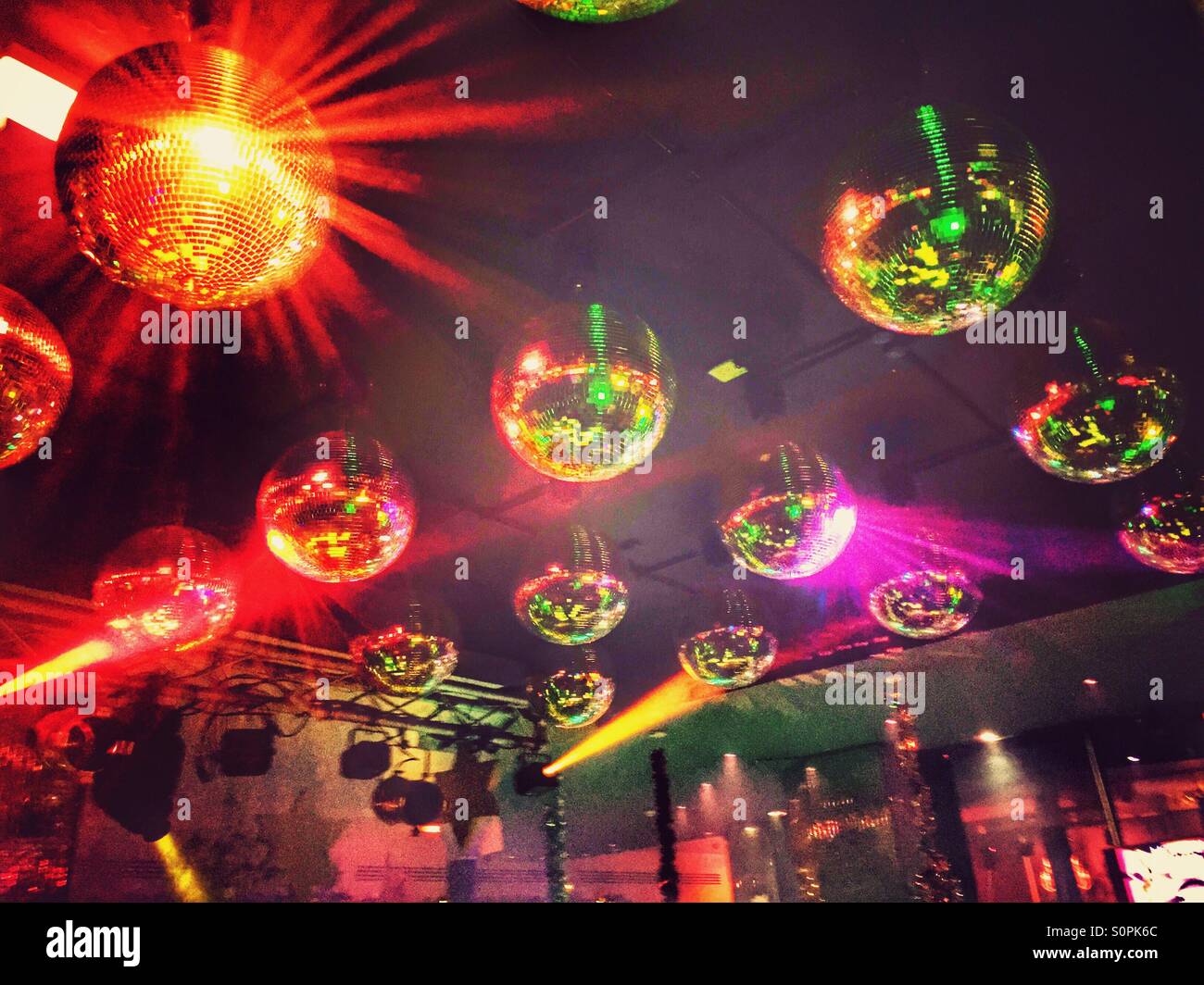 Silver and gold disco balls hang from the ceiling on New Years eve Holiday  Stock Photos