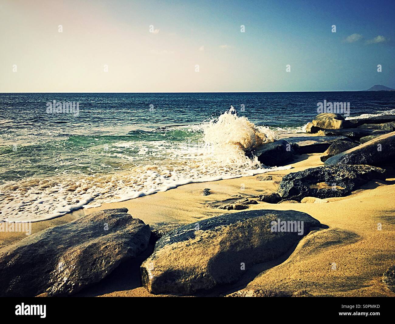 Waves crashing on a rocky sandy beach - Smartphone Captured Stock Image