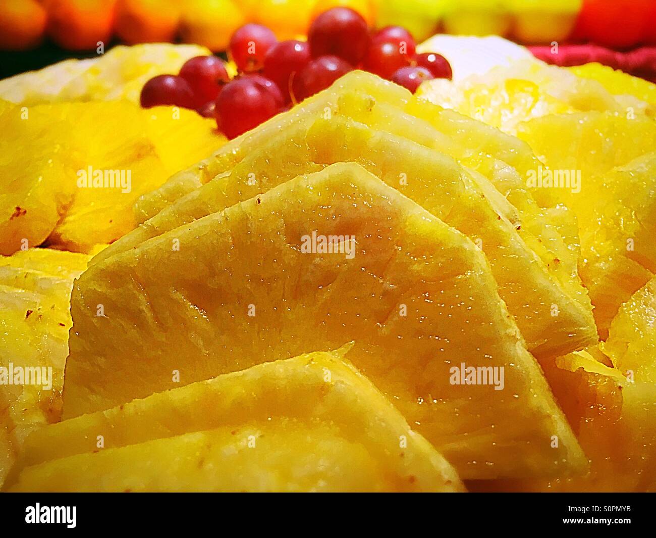 Slices of pineapple and red grapes - Smartphone Captured Stock Image