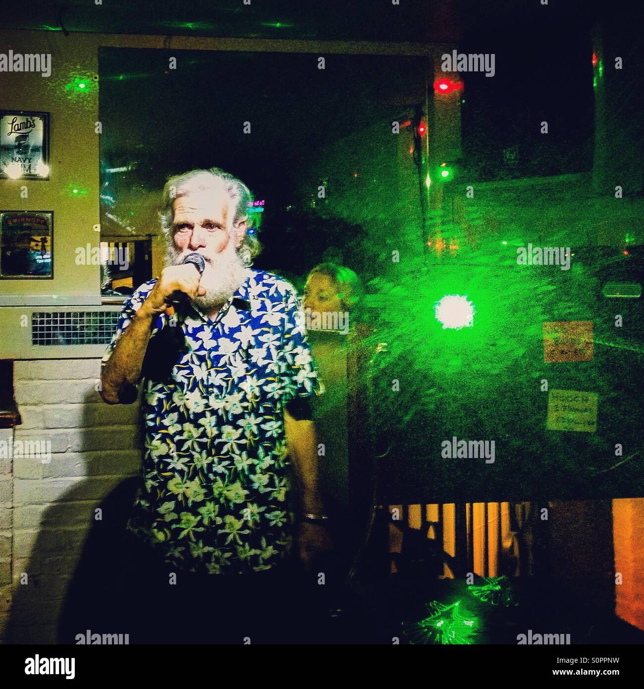 An Old Karaoke Performer In Small British Pub Stock Photo