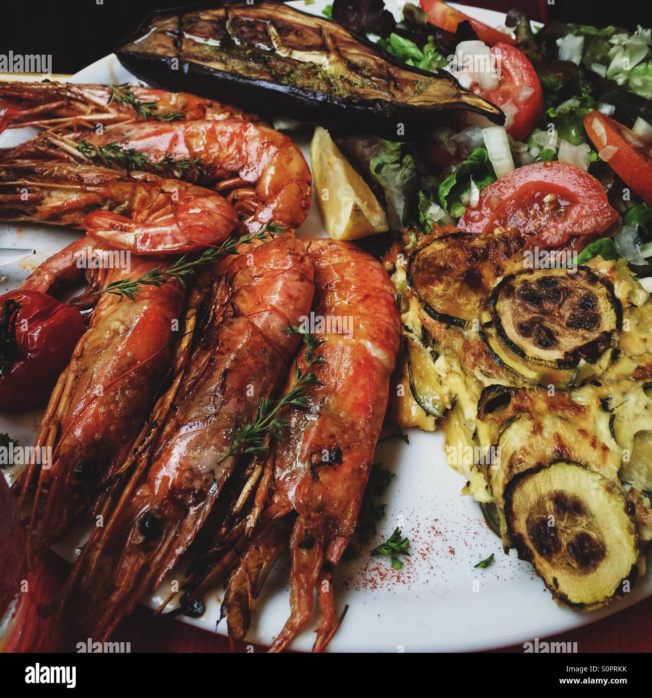 Prawns grilled and served with a quiche and vegetables - Smartphone Captured Stock Image