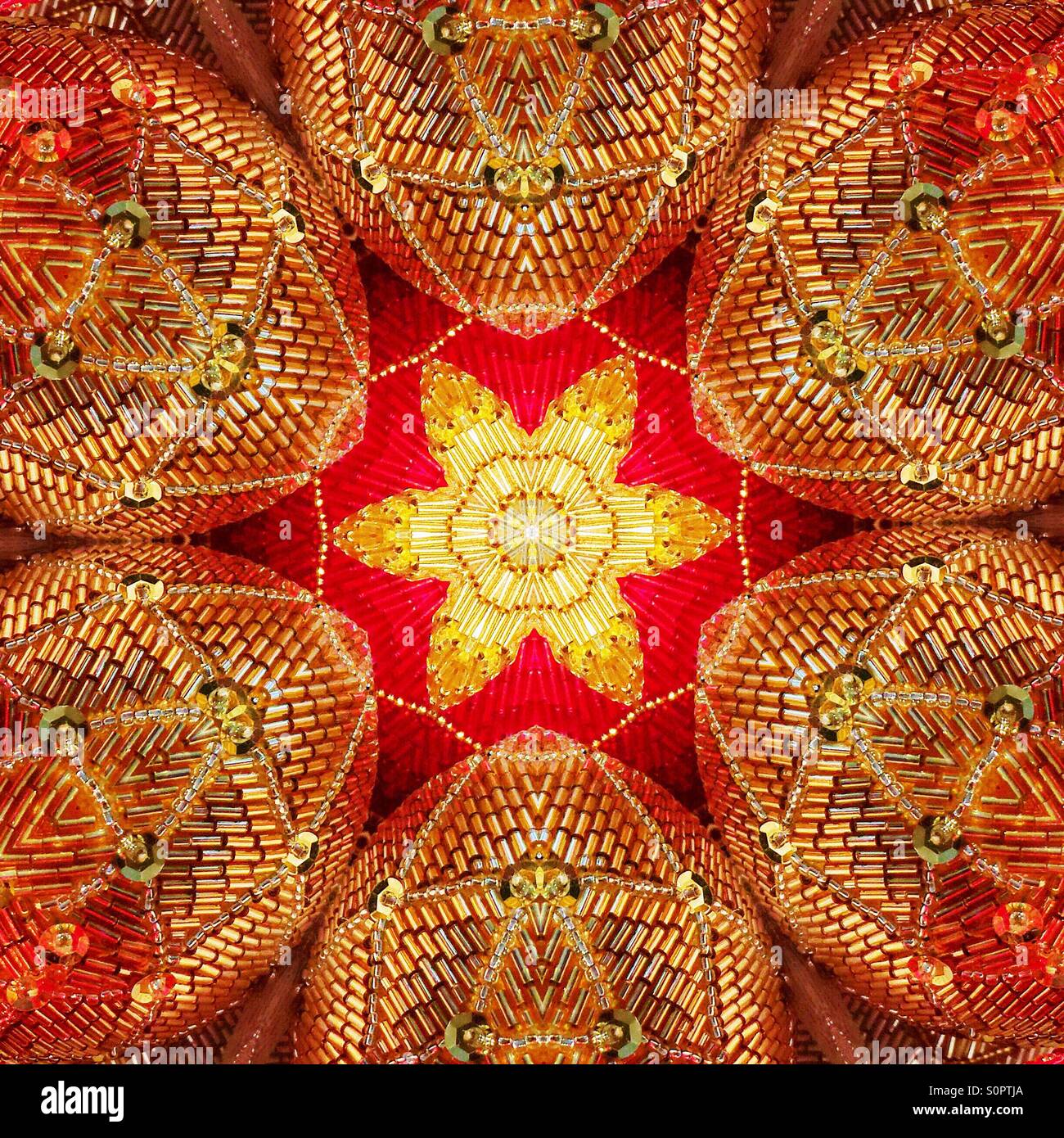 A macro kaleidoscopic image of sequined, sparkly ornaments with a star burst or flower shape in the center - Smartphone Captured Stock Image