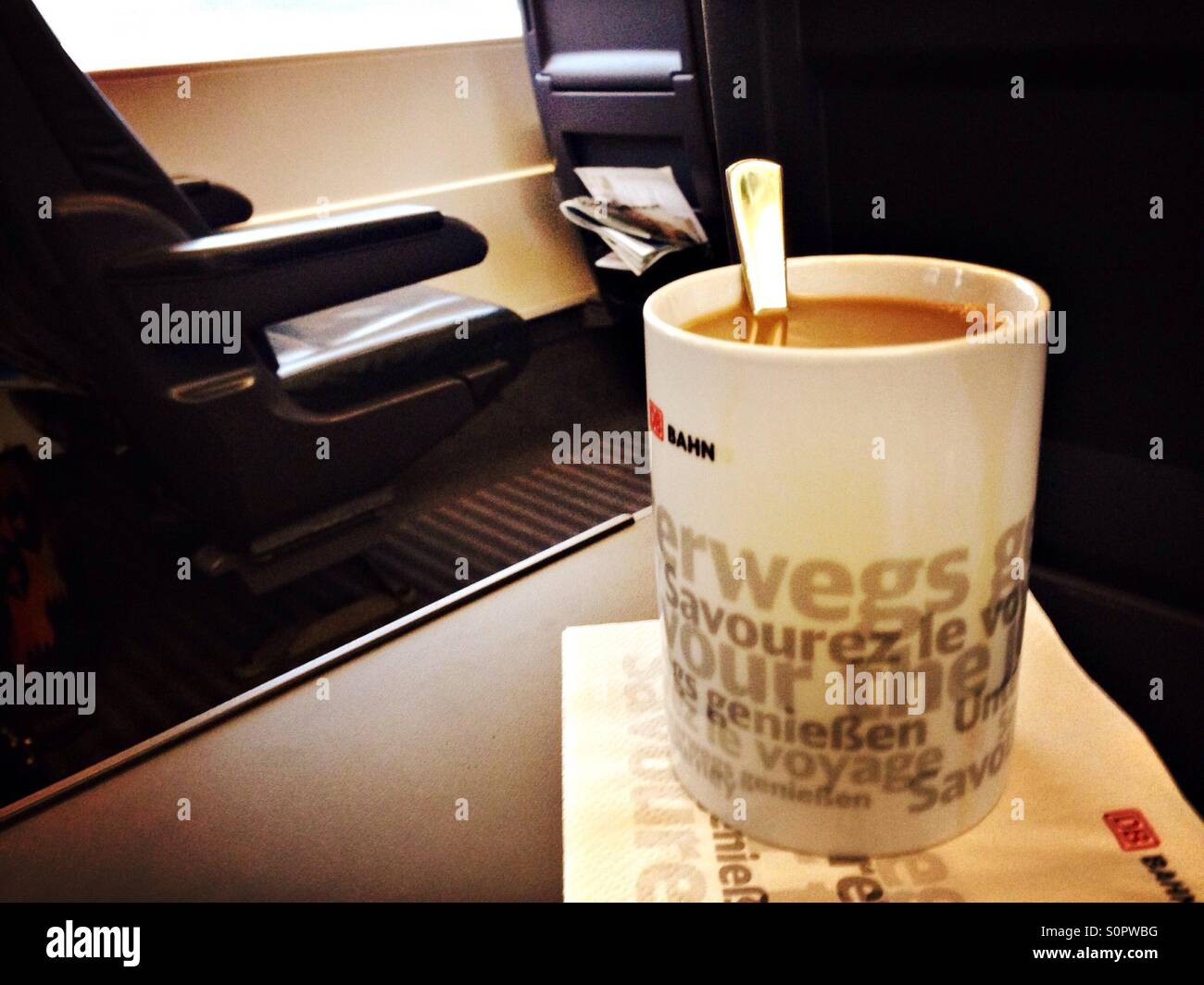 Coffee with milk while traveling in the first class coach of the ICE train of the German Deutsche Bahn, Germany - Smartphone Captured Stock Image
