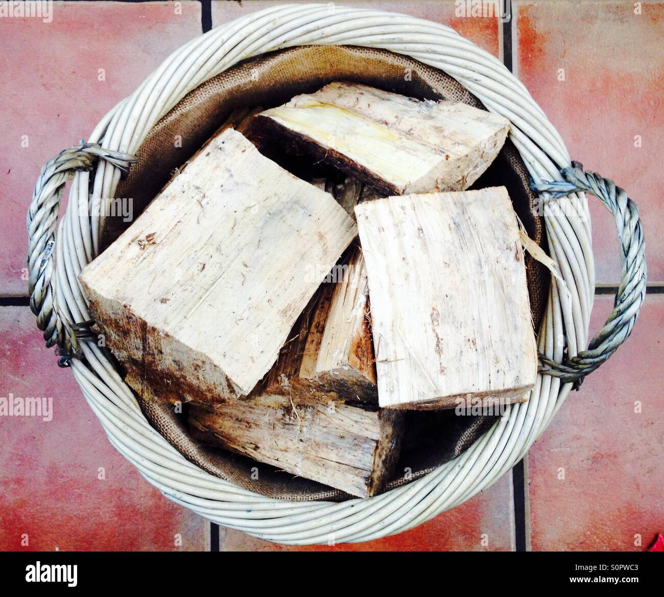 Firewood logs in wicker basket - Smartphone Captured Stock Image