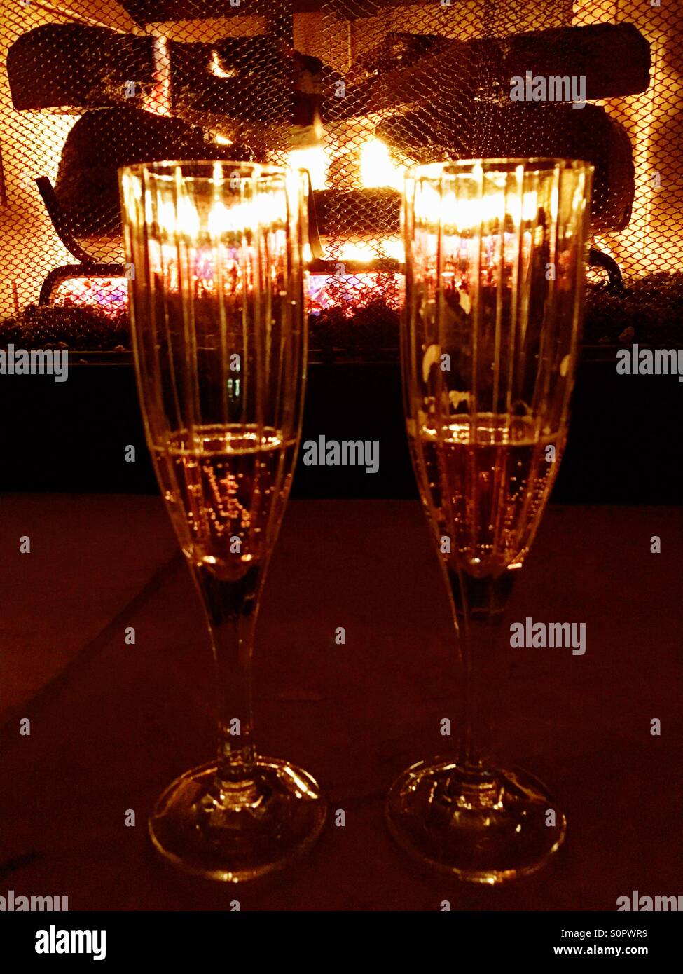 Champagne toast by the fireplace - Smartphone Captured Stock Image