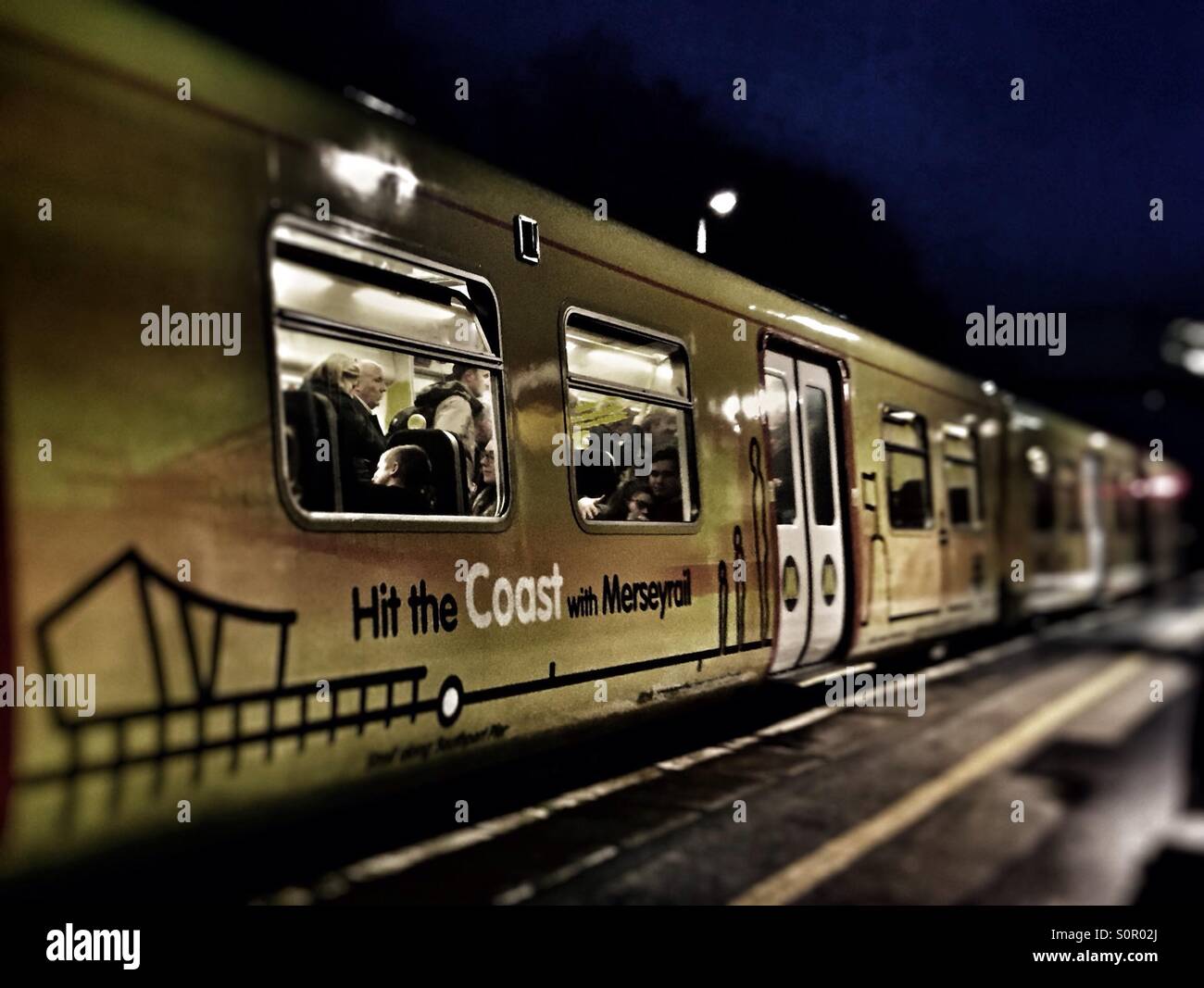 Mereyrail train arriving at Maghull Station Stock Photo - Alamy
