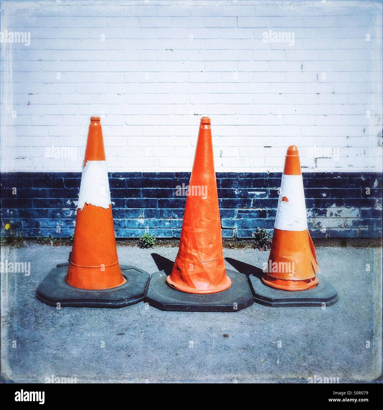 Three distressed traffic cones Stock Photo