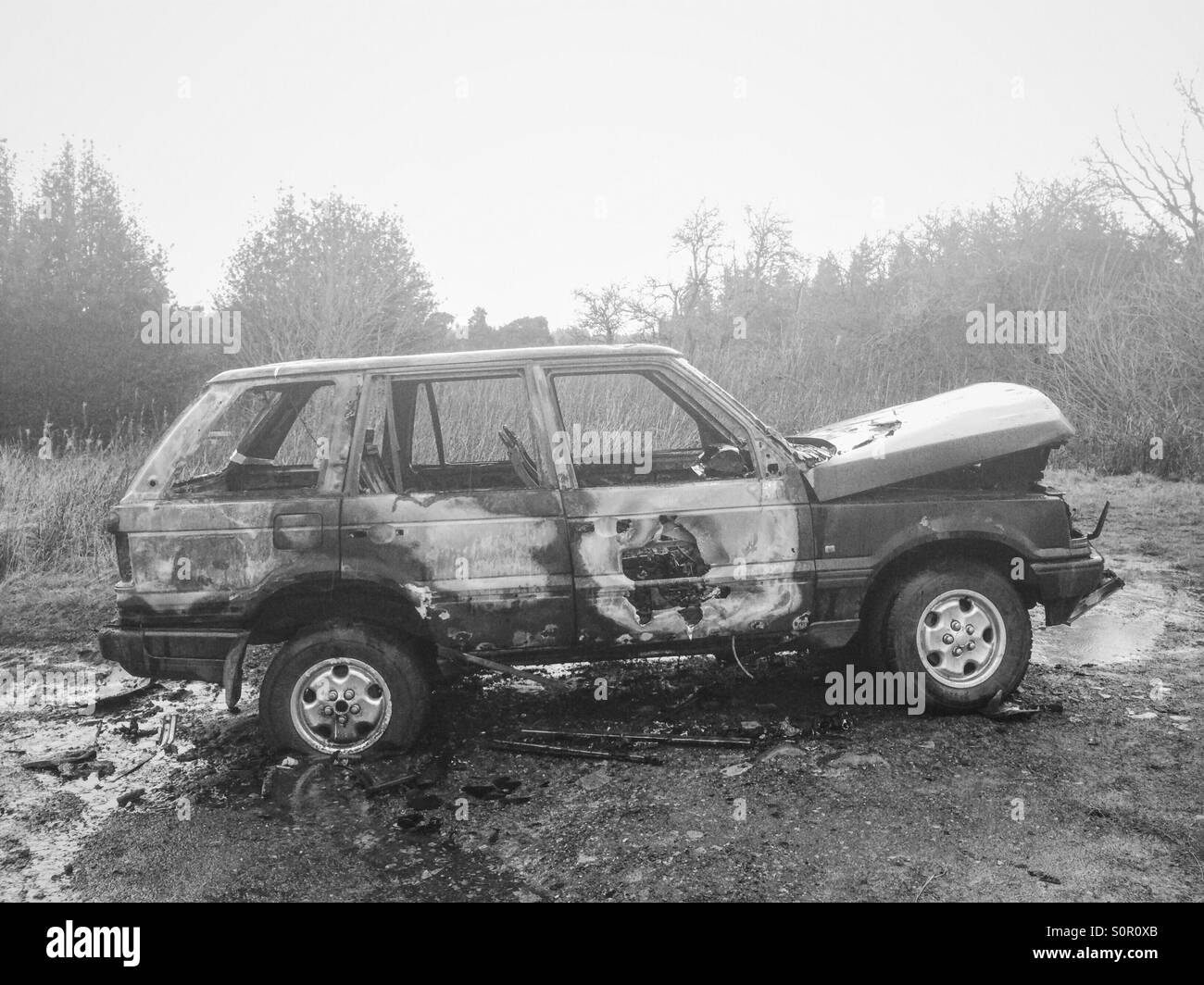 A burnt out Range Rover in rural Northumberland, UK. - Smartphone Captured Stock Image