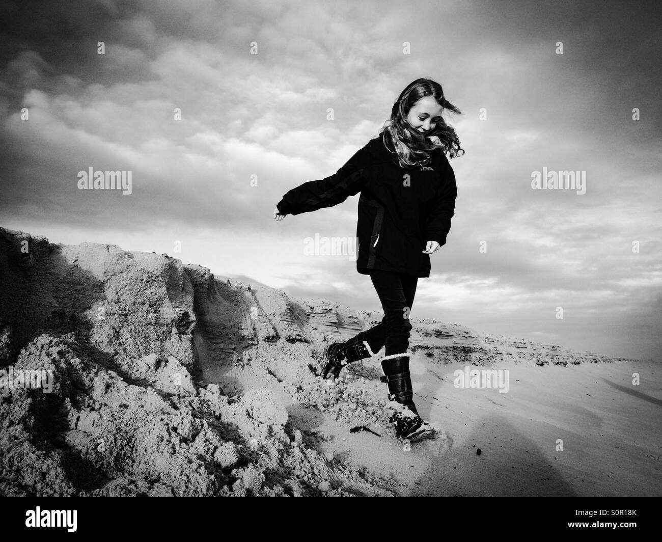 An 11 Year Old Girl Having Fun On Winterton Beach In Norfolk Stock an-11-year-old-girl-having-fun-on-winterton-beach-in-norfolk-stock
