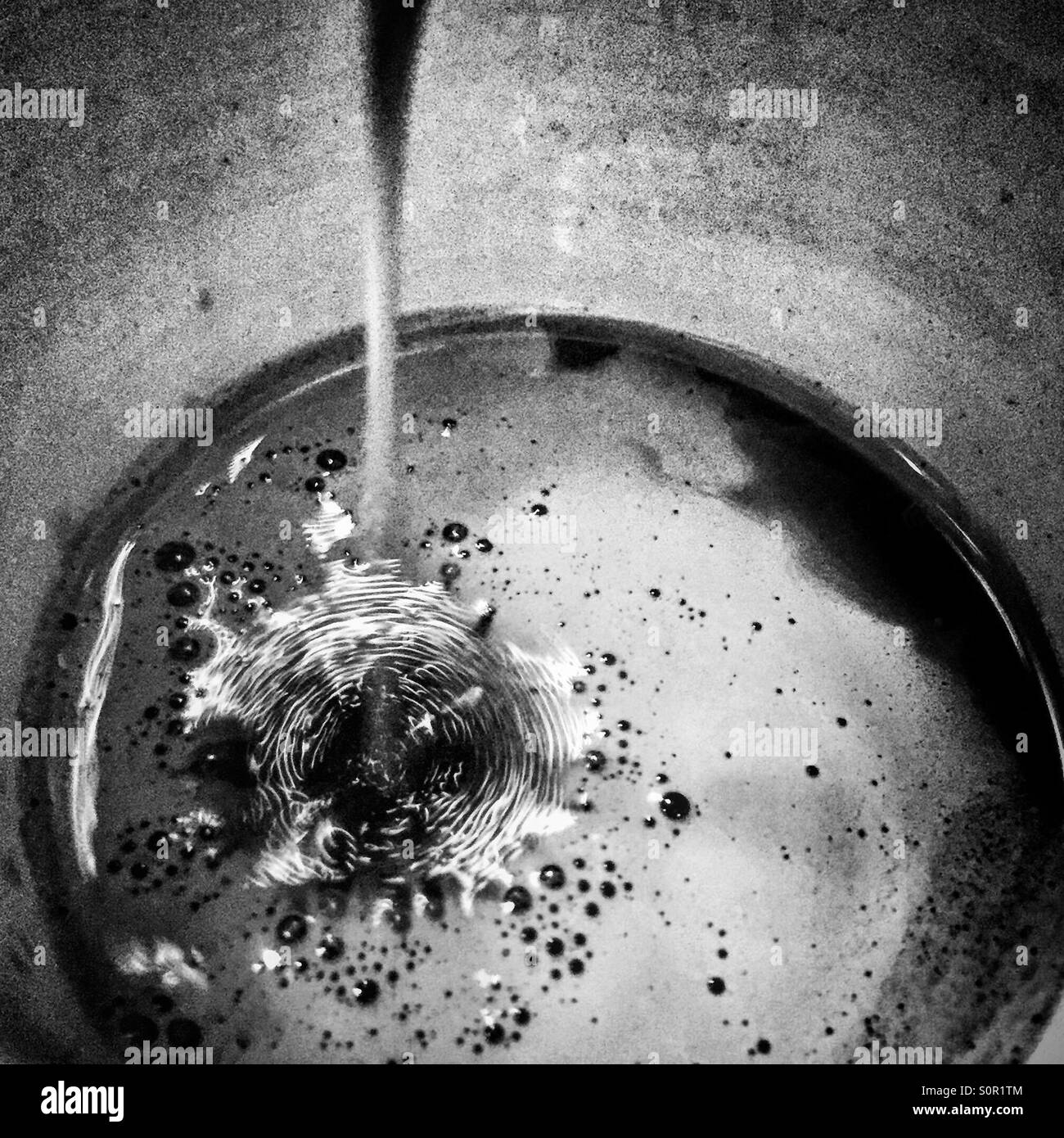 Pouring expresso coffee at home in a home coffee machine - Smartphone Captured Stock Image