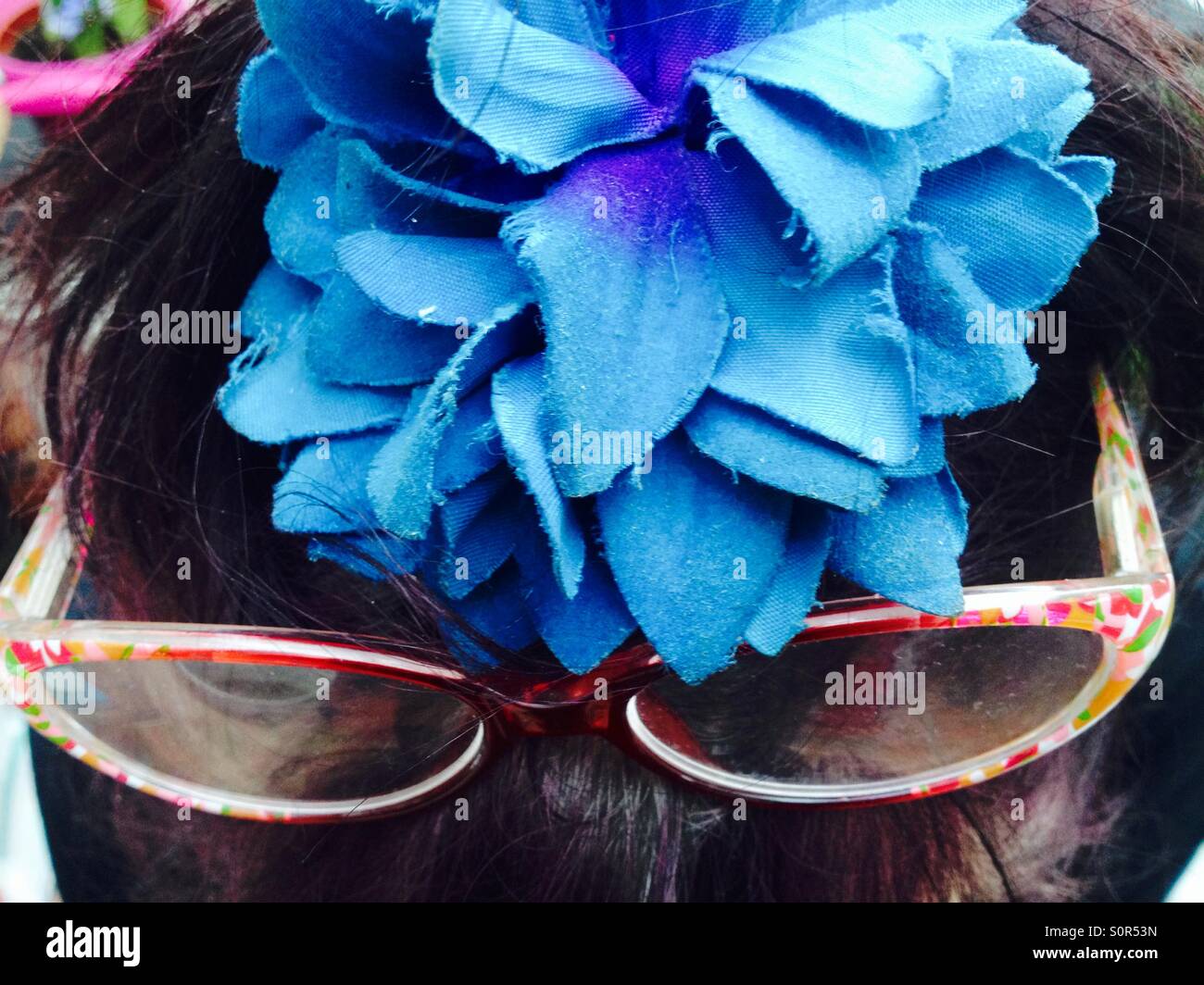 Woman with reading glasses on her head - Smartphone Captured Stock Image