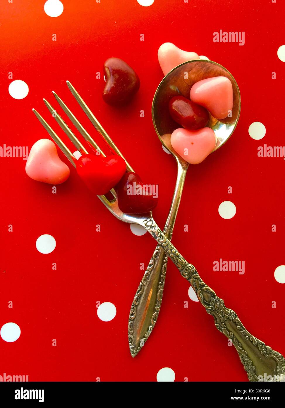 Valentine candy hearts on a fork and spoon - Smartphone Captured Stock Image