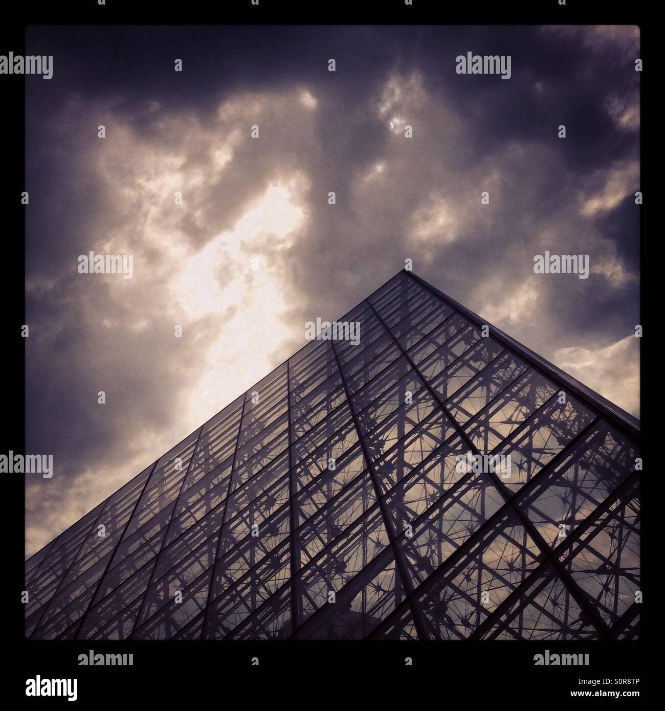 The Louvre in Paris in front of a moody grey sky - Smartphone Captured Stock Image