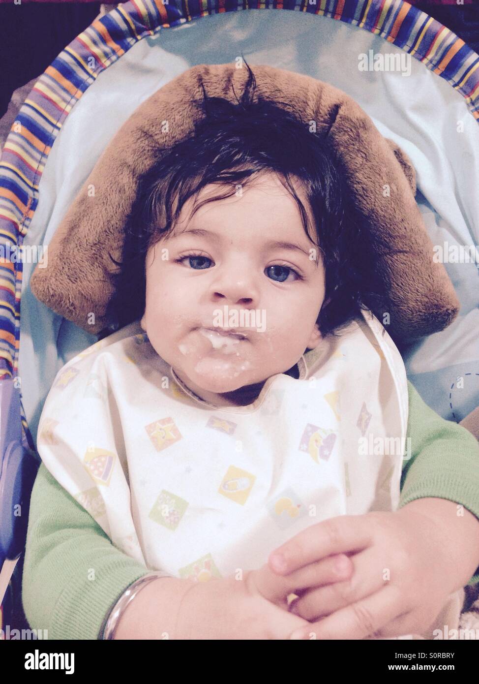 Baby boy after eating his first time cereal. Stock Photo