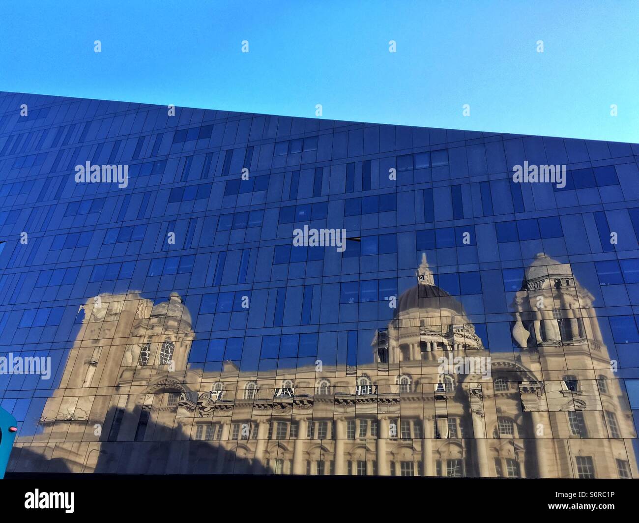Port of Liverpool building reflected in Mann Island building Stock Photo