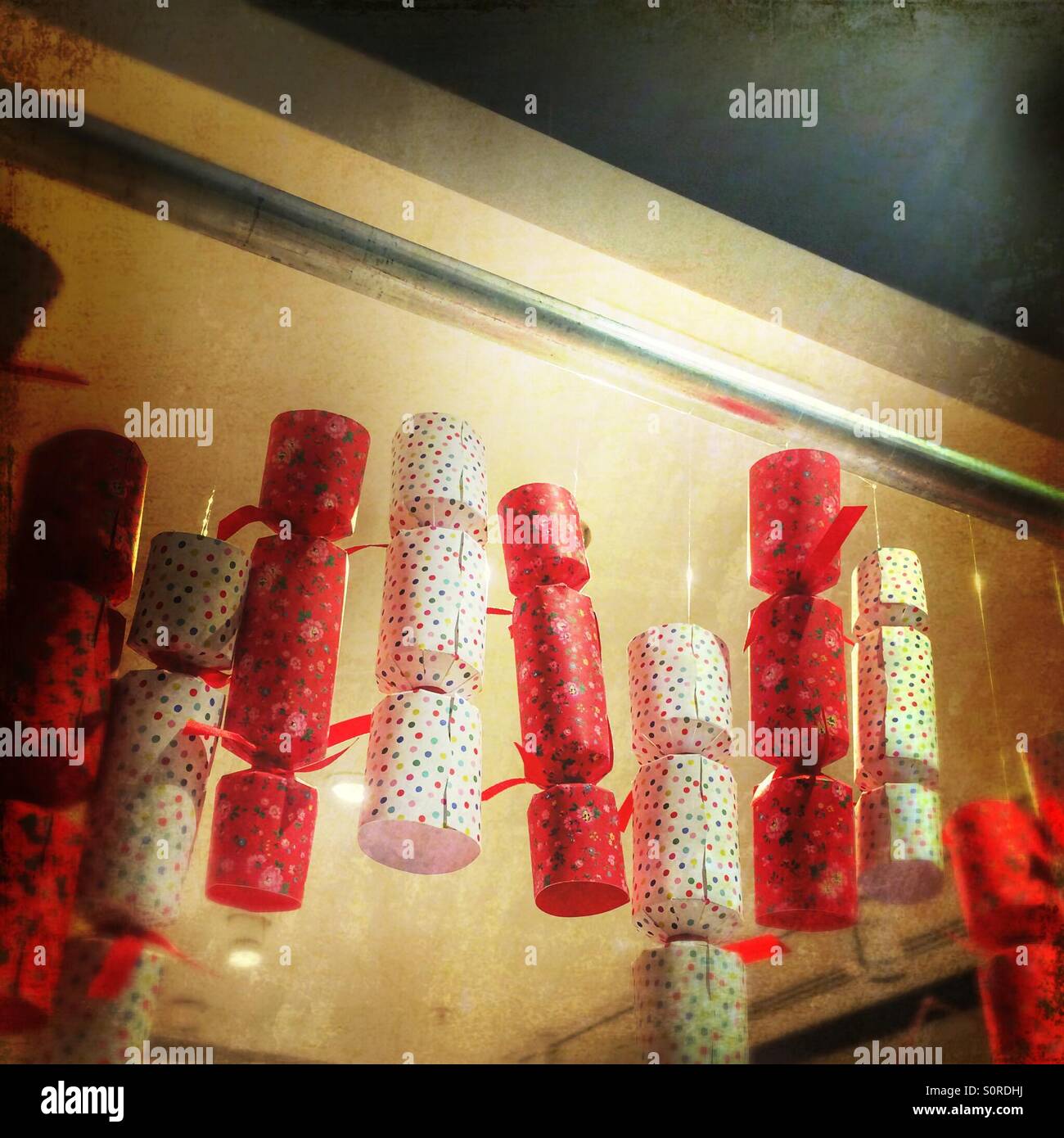 Christmas crackers hanging from a ceiling rail - Smartphone Captured Stock Image