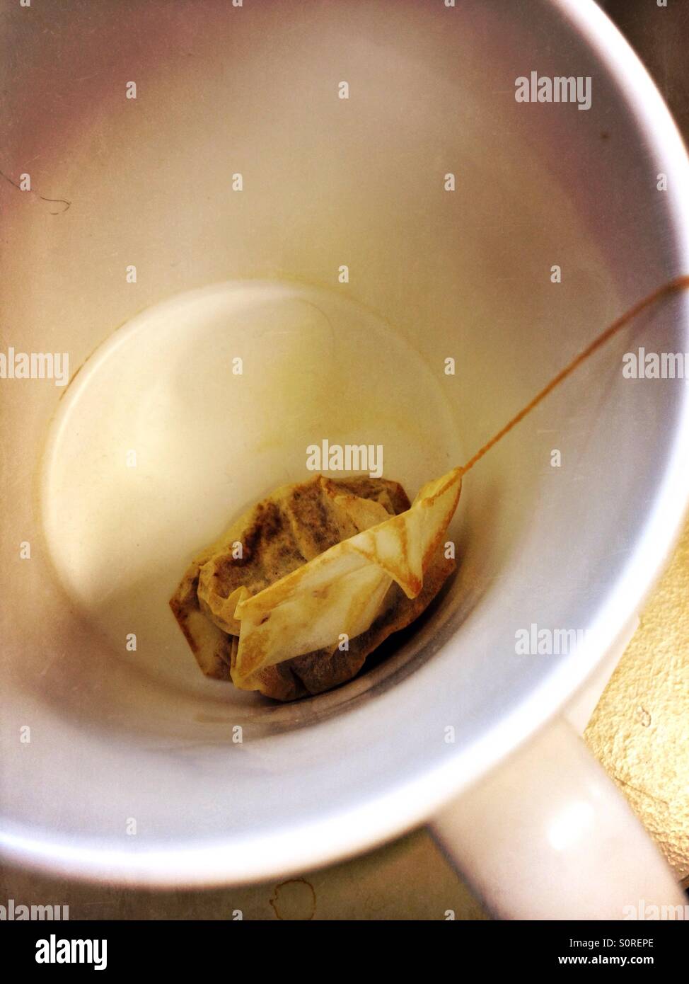 Used tea bag at the bottom of a mug or cup - Smartphone Captured Stock Image