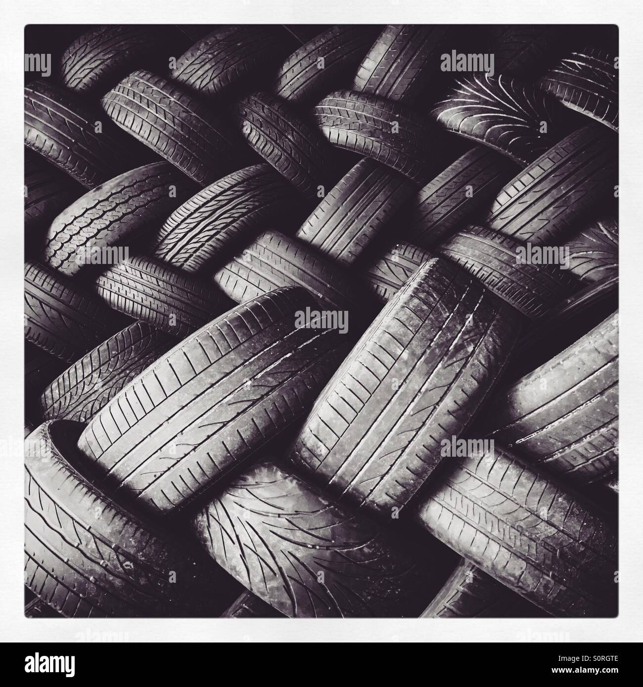 A pile of used car tyres. Stock Photo
