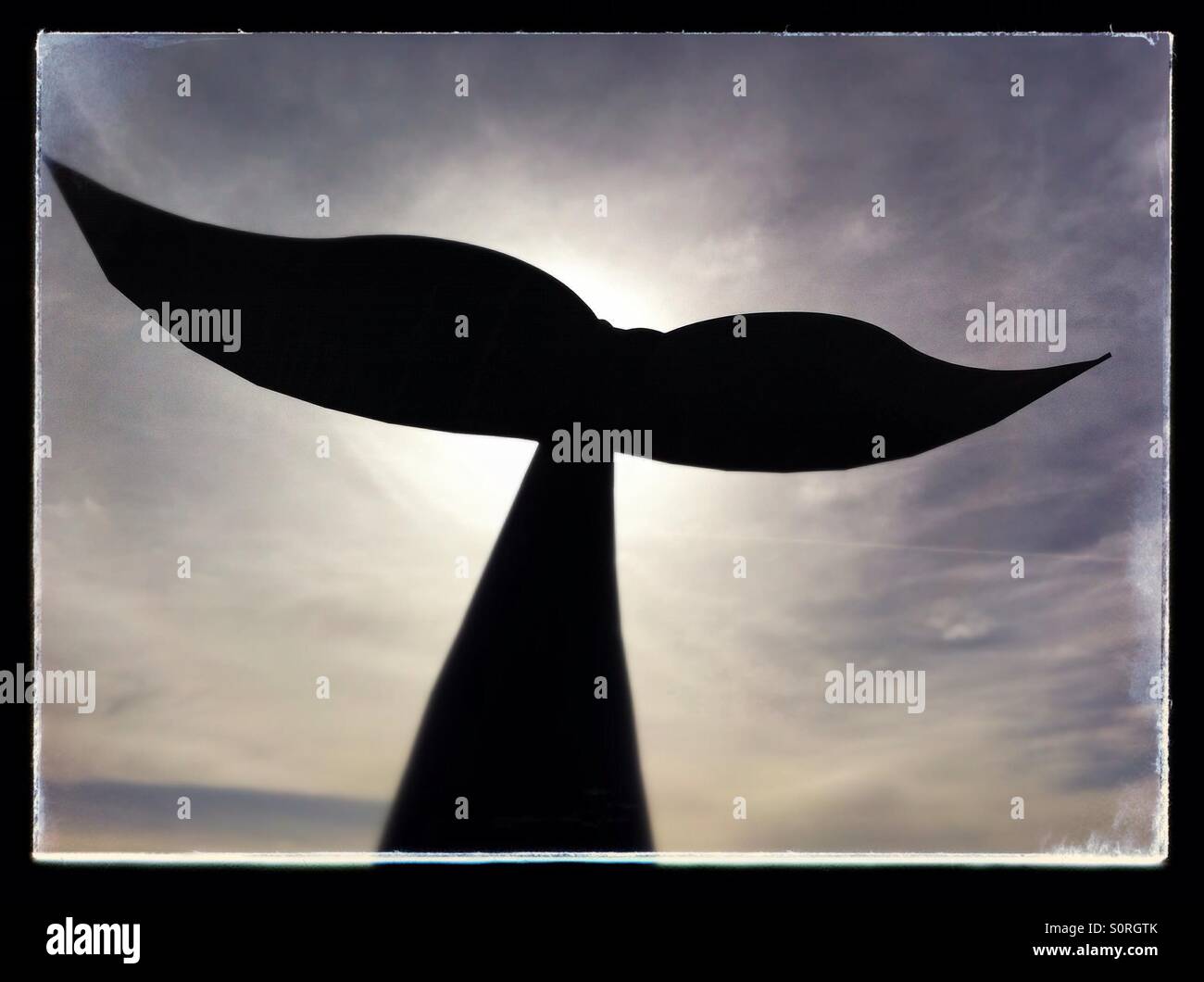 Whale's tail statue that stands on the Oeiras Boardwalk in Lisbon, Portugal. - Smartphone Captured Stock Image