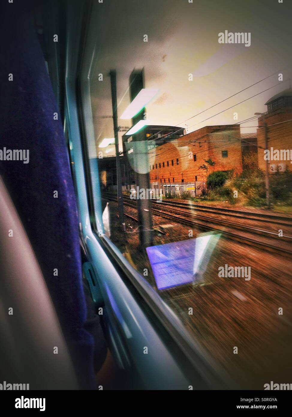 Looking out the window of a train on it's way into Paddington. You can see reflections from inside the carriage in the window. - Smartphone Captured Stock Image