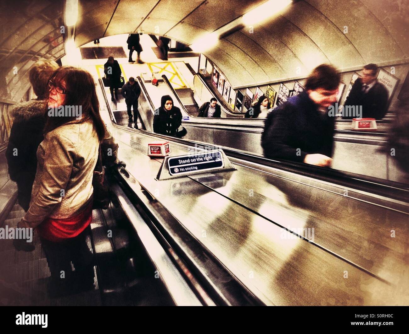 Traveling down an escalator in a London Underground station. - Smartphone Captured Stock Image