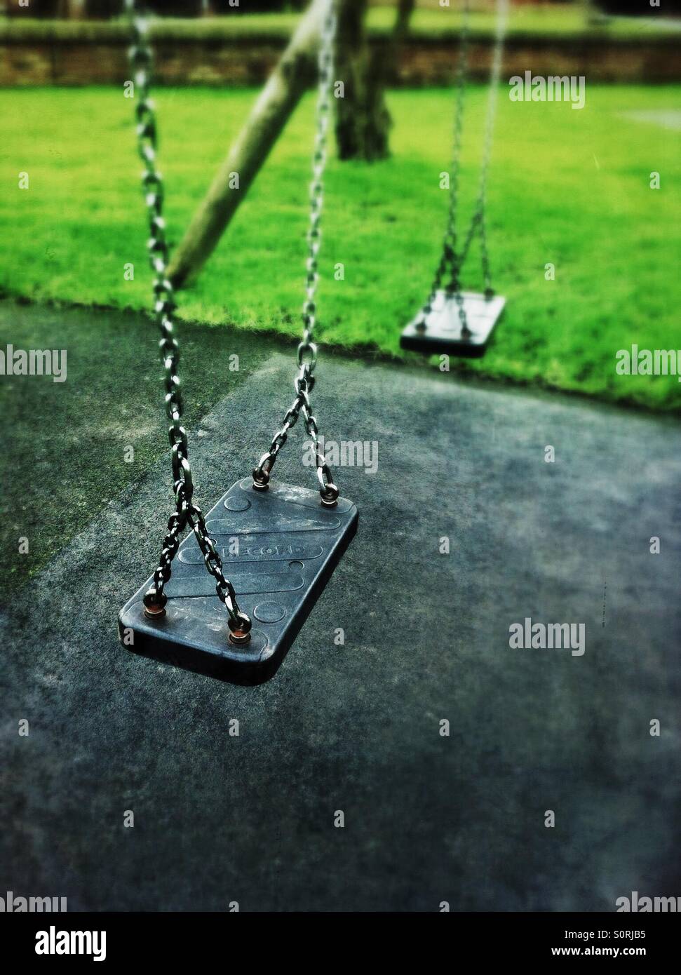 Empty swings in children's play area - Smartphone Captured Stock Image