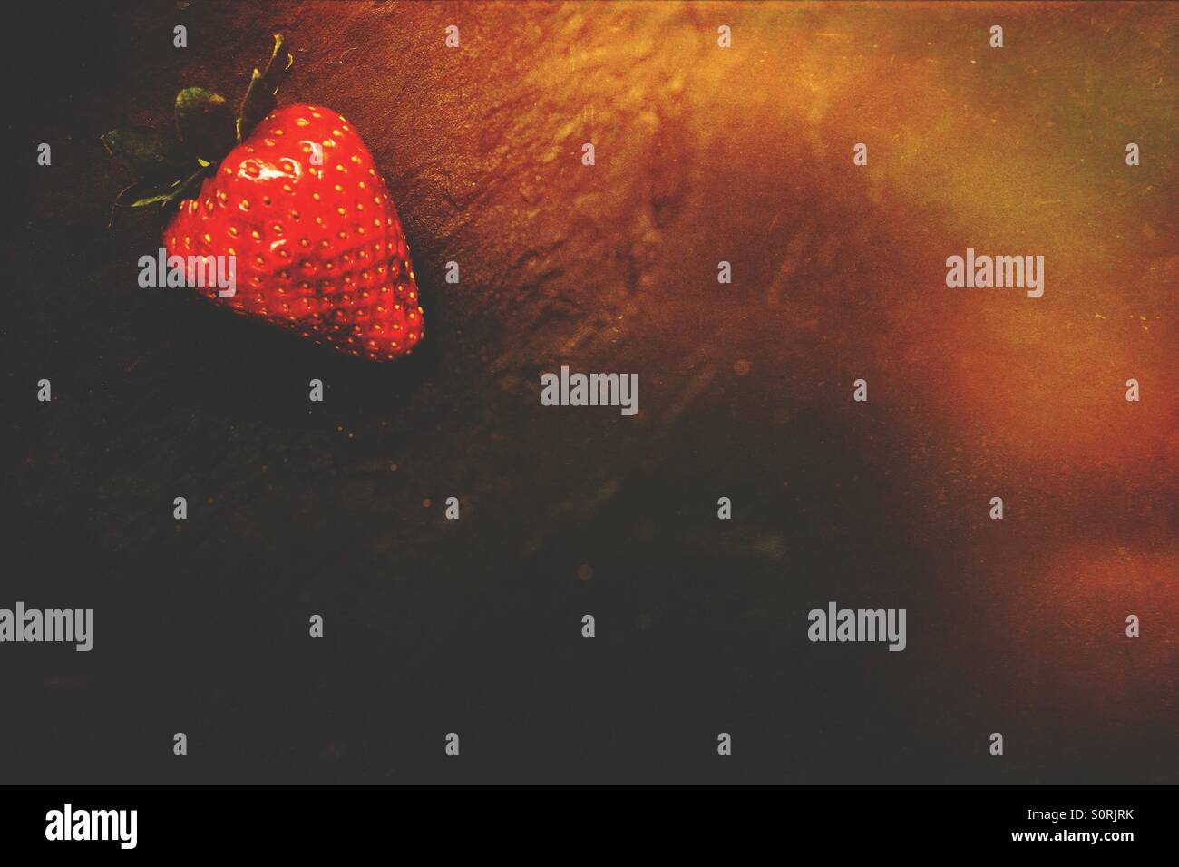 Strawberry isolated on black stone top - Smartphone Captured Stock Image