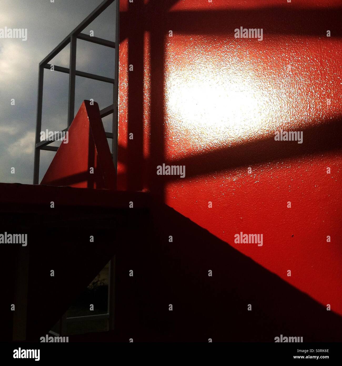 Shiny red paint on a jungle gym Stock Photo