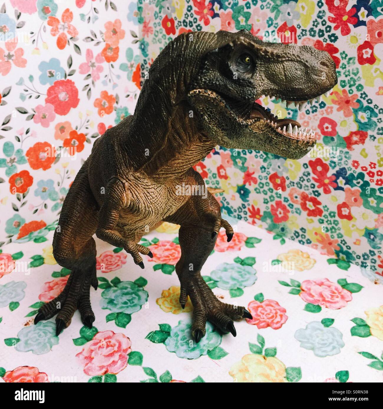 Model of dinosaurs T-Rex  on happy flowery background - Smartphone Captured Stock Image