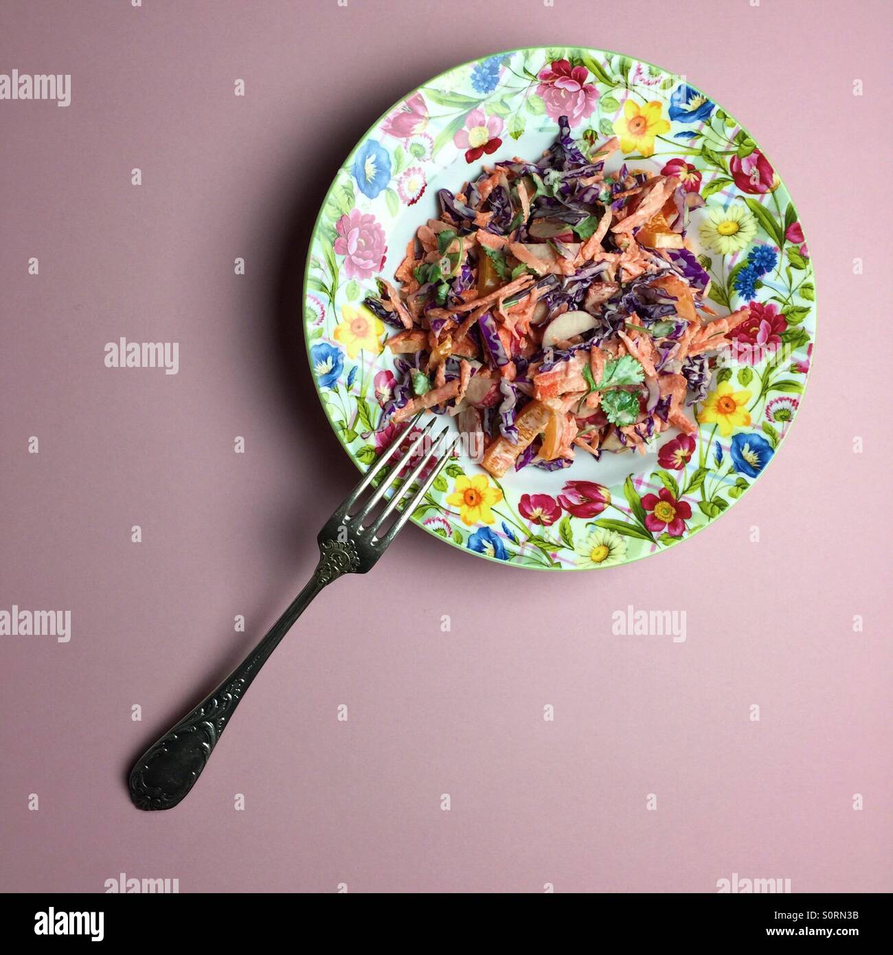 vegan coleslaw on a plate with flowers - Smartphone Captured Stock Image