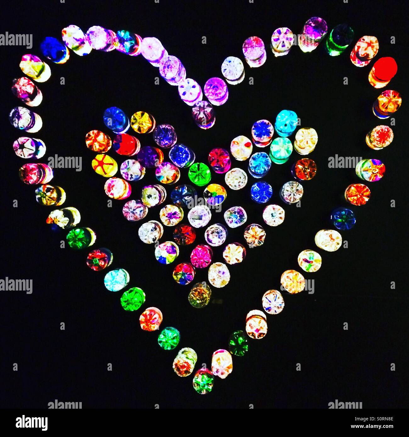 A love heart made out of coloured bottles Stock Photo