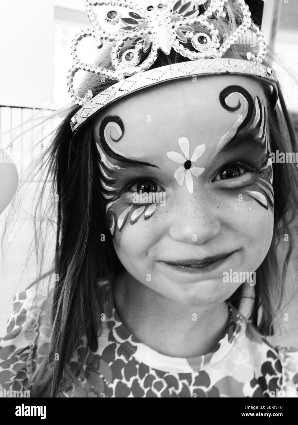 Girl with face paint and tiara Stock Photo