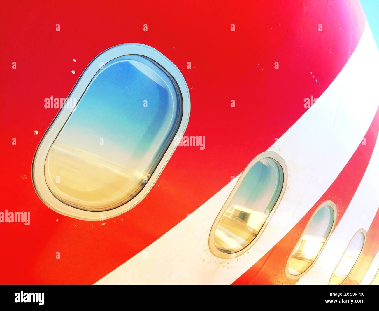 Air Asia plane windows seen from the outside Stock Photo - Alamy