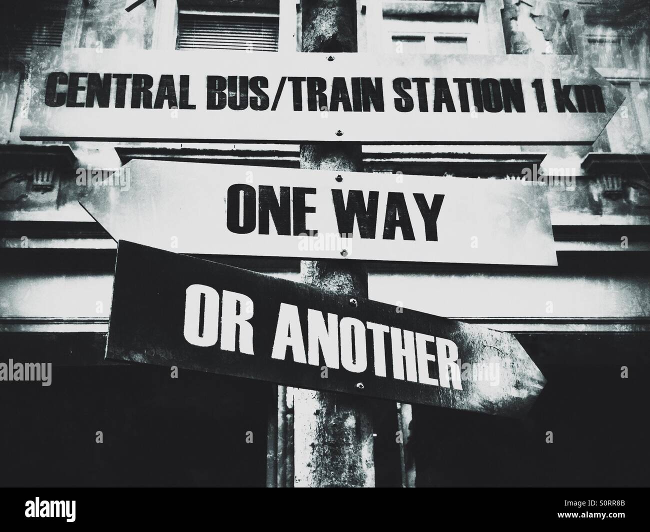 Wooden sign indicating One way or another and Central bus/train station - Smartphone Captured Stock Image