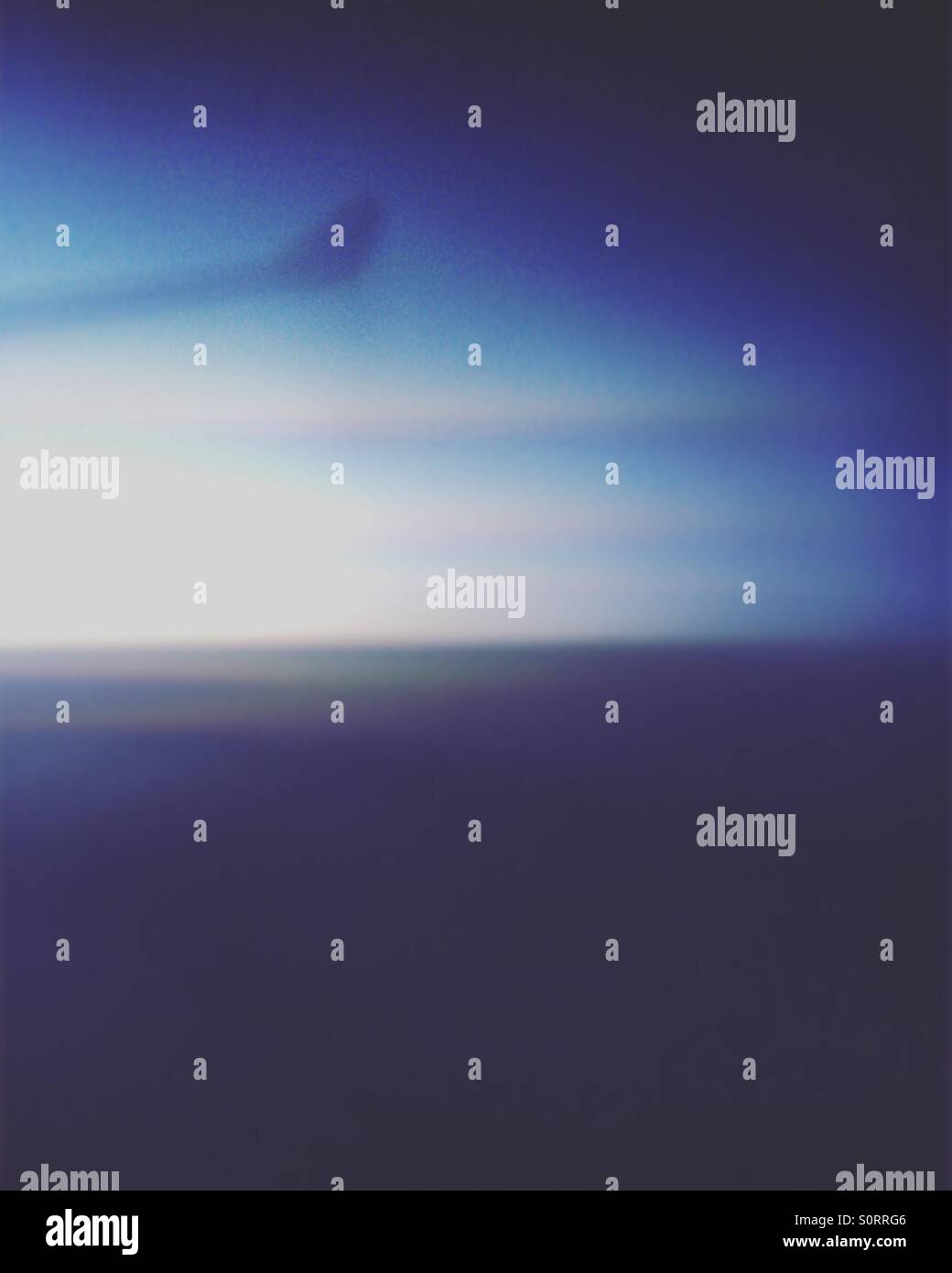 Long exposure view from an airplane window flying over Canada at dusk. - Smartphone Captured Stock Image