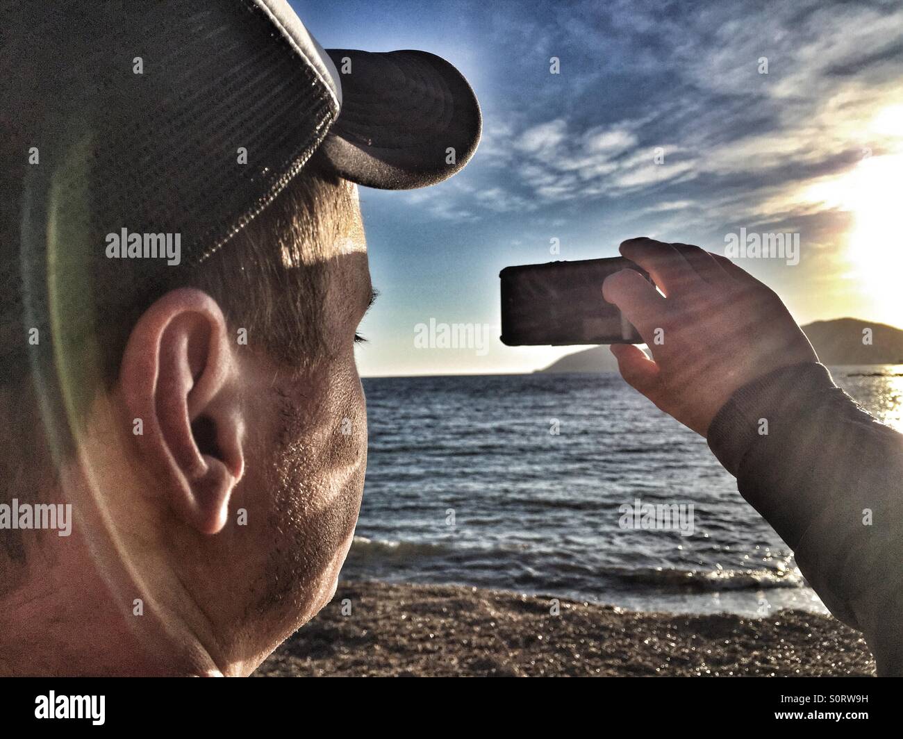 Man taking a photo with an iPhone Stock Photo