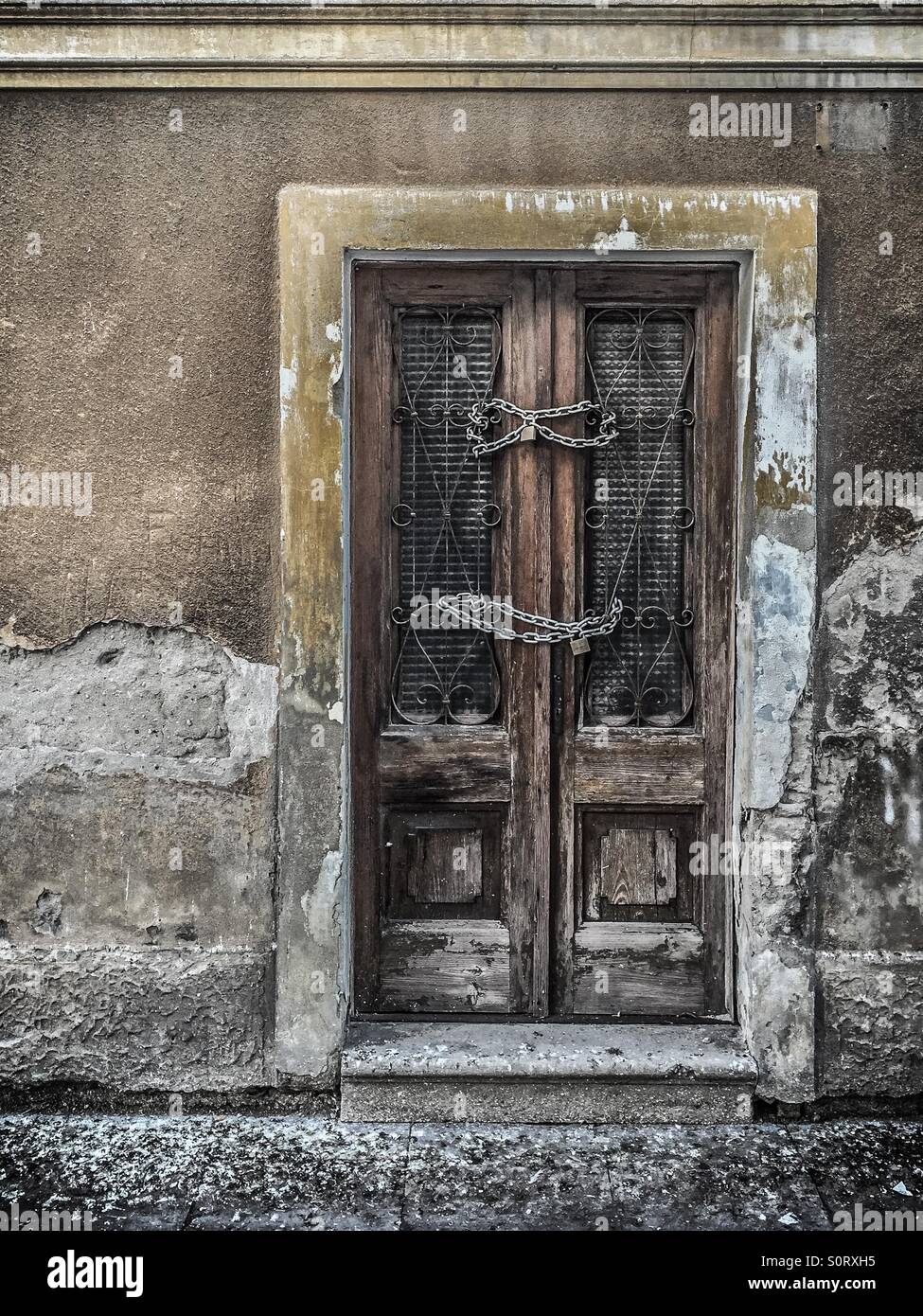 Old wooden door with chain and padlock - Smartphone Captured Stock Image