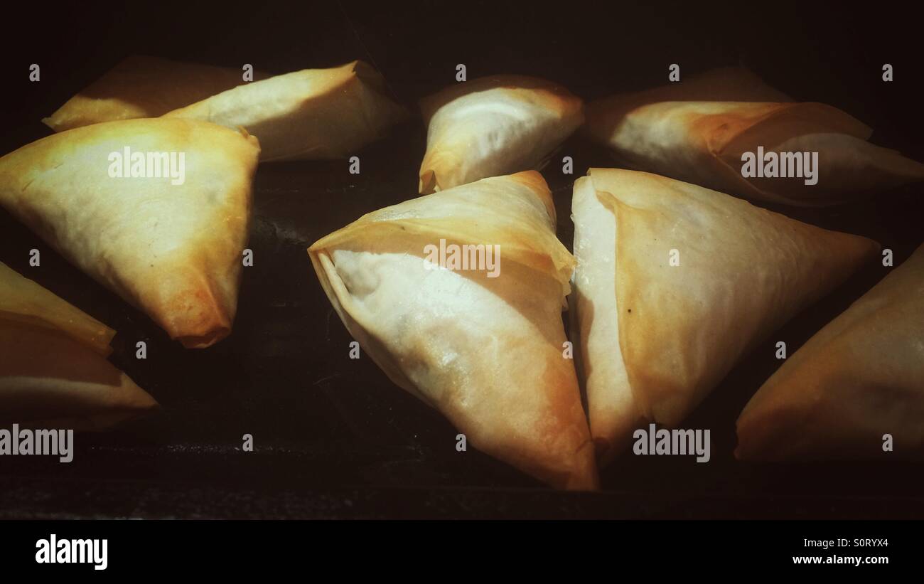 Freshly baked filo pastry Greek pies known as Tiropitakia. - Smartphone Captured Stock Image