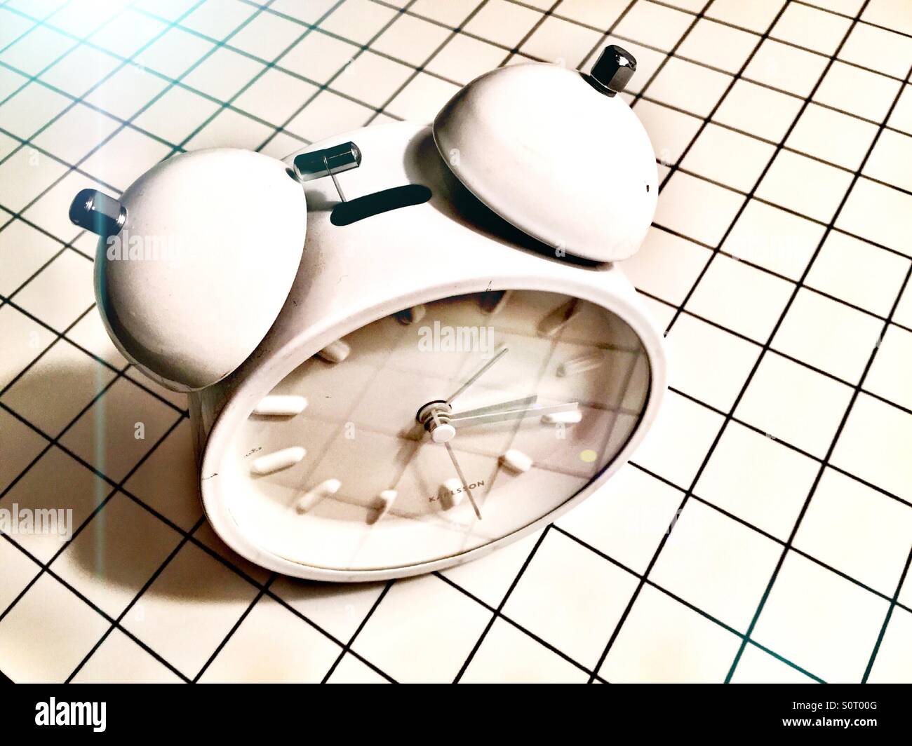 Alarm clock with two ringers and no numbers on a white background - Smartphone Captured Stock Image