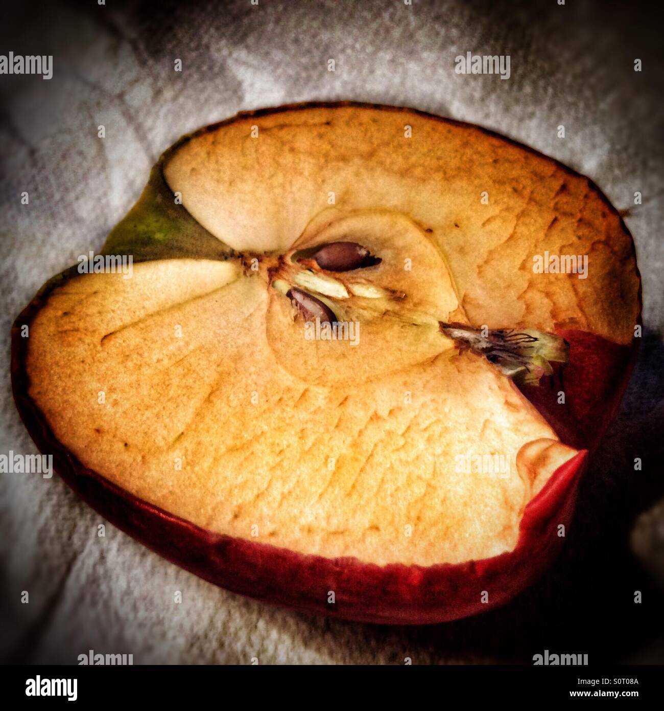 An apple cut in half and has oxidised. - Smartphone Captured Stock Image