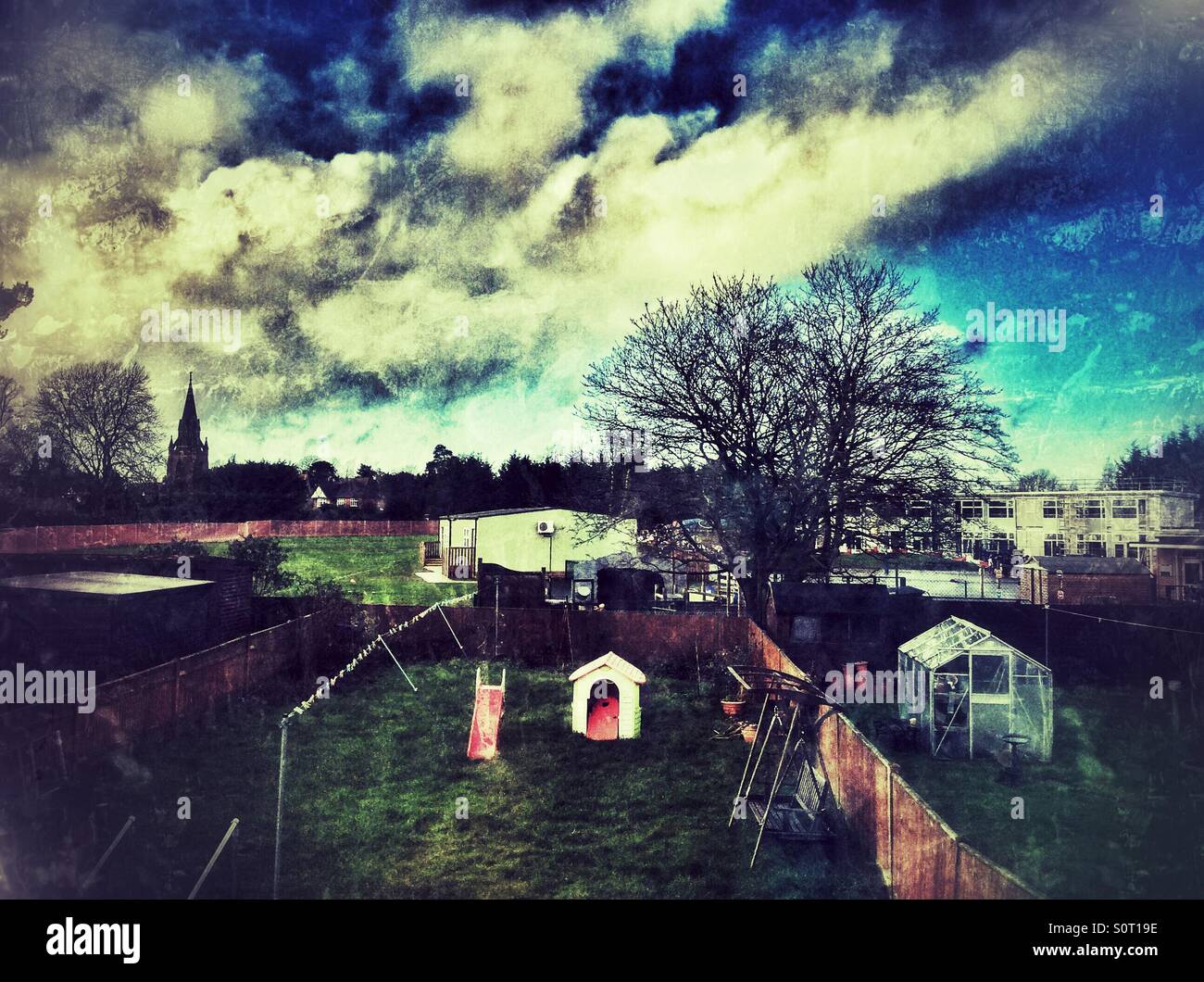 Looking out an upstairs window at the back garden and the school playing fields beyond. - Smartphone Captured Stock Image