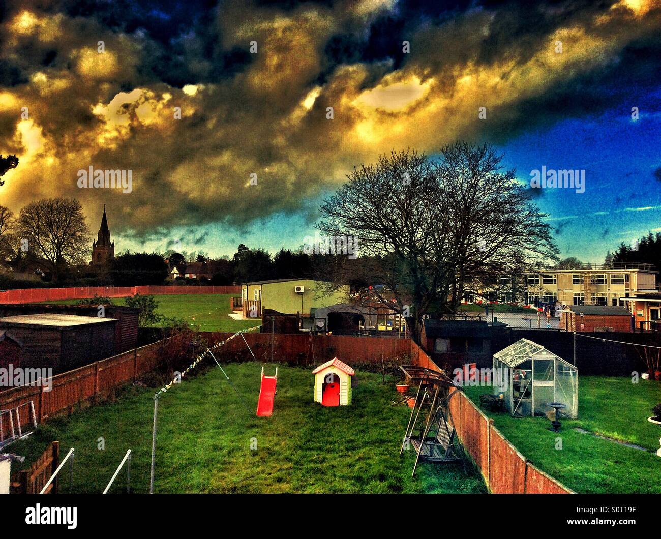Looking out an upstairs window at the back garden and the school playing fields beyond. - Smartphone Captured Stock Image