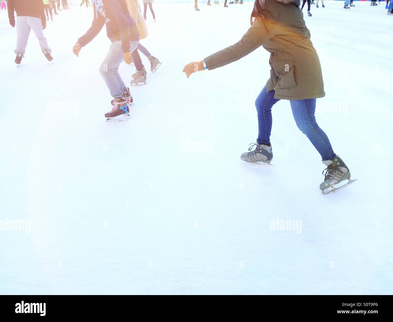 Skaters in motion on skating rink in Bryant Park winter of 2016 - Smartphone Captured Stock Image