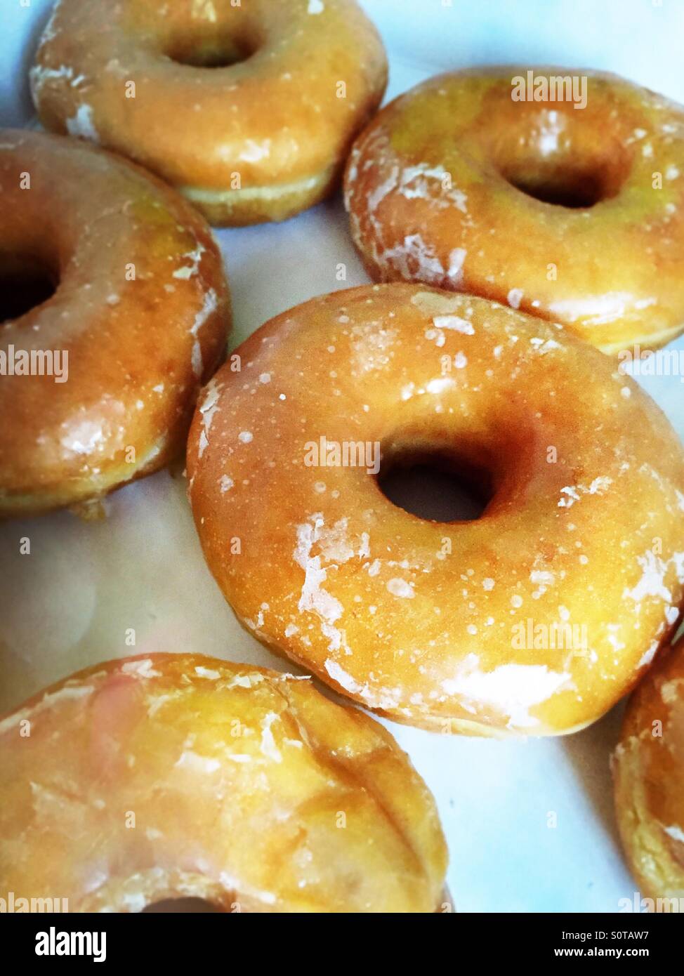 Glazed doughnut it's in a delivery box - Smartphone Captured Stock Image