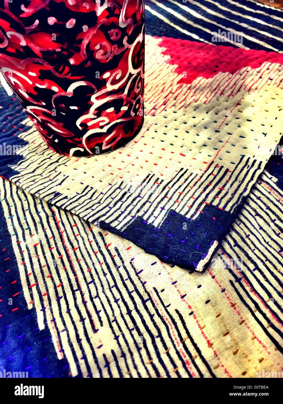 Close-up detail of textured coasters and print tea mug - Smartphone Captured Stock Image