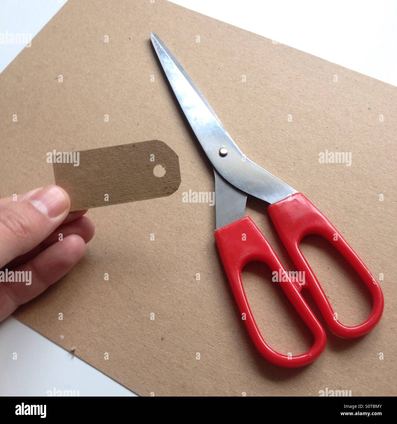 Cardboard scissors Cut Out Stock Images & Pictures - Alamy