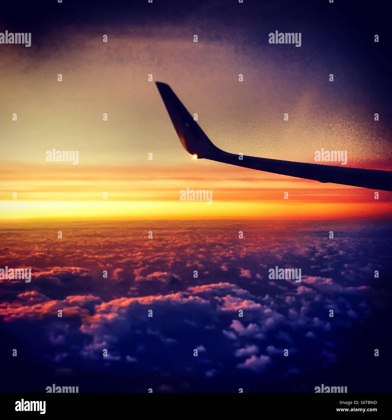 Sunrise through a passenger jet window Stock Photo - Alamy
