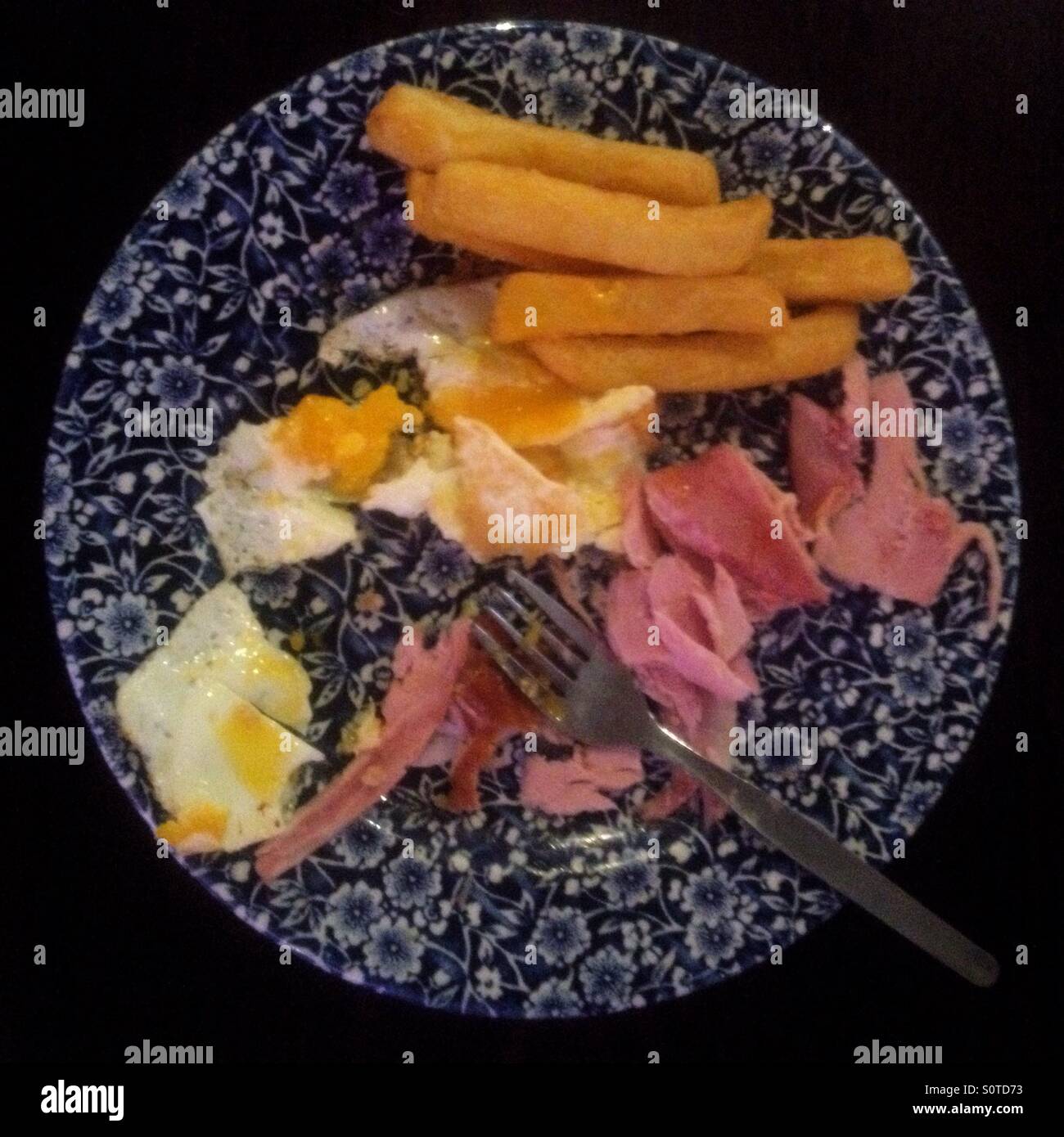 A child's half eaten plate of ham, egg and chips Stock Photo Alamy