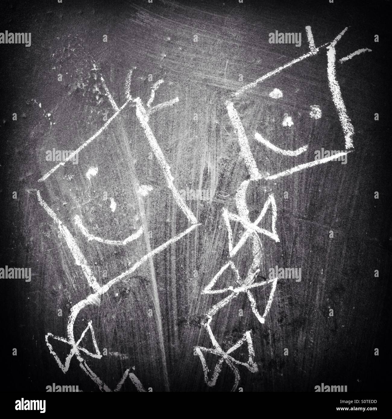 Kites drawn with white chalk on a black chalkboard - Smartphone Captured Stock Image